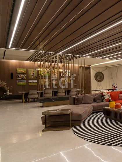 This capacious living room exudes modern luxury through its vast dimensions and minimalist aesthetic. We used an earthy color palette and integrated diverse materials like wood, marble, and metal to create an atmosphere of refined opulence that feels both uncluttered and inviting.