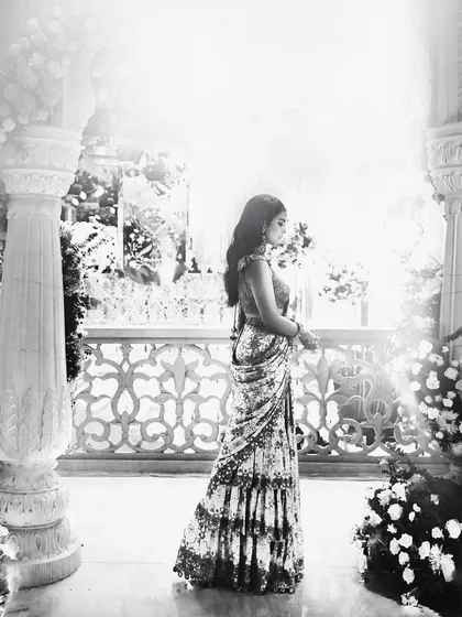 A beautiful black and white shot that captures the timeless elegance of the Arpita Mehta saree. The play of light and shadow highlights the silhouette and intricate details.