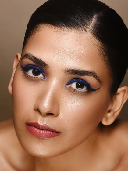 A full-face view of the graphic eyeliner look. This type of clean, polished beauty photography is effective for campaigns that need a modern and confident feel.