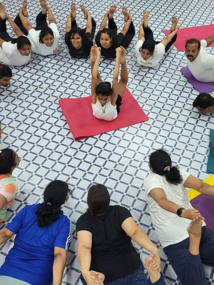 Another creative formation from our Yoga Day celebration. This pose requires flexibility and coordination from the entire group.