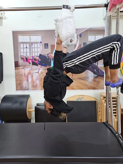 A client enjoying the feeling of hanging upside down on the Cadillac. It's a challenging move that's also incredibly fun and liberating.