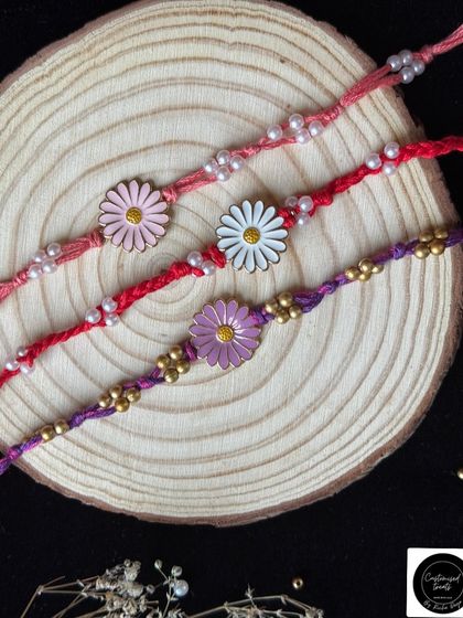 Simple and sweet daisy charm rakhis. These minimal designs come in various colors and are perfect for celebrating the pure and simple bond you share with your brother.