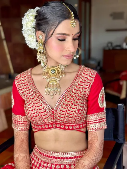 A close-up of the bridal look, showing the intricate details of the blouse, the gajra in her hair, and the soft, elegant makeup.