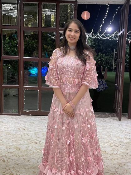 An iconic look for a young fashionista. This embroidered Indo-Western crop top with a cape and skirt is a dreamy outfit for a sister of the bride or groom.