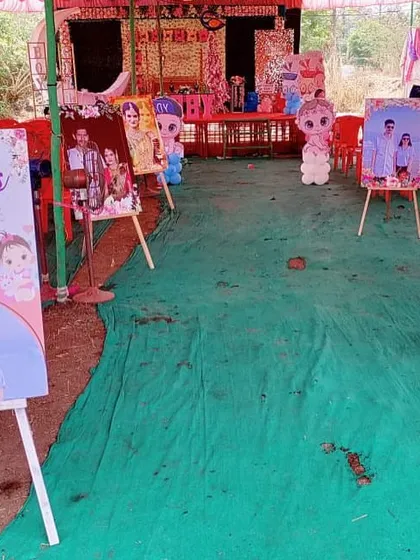 A gallery of the couple's photos displayed on easels along the entrance path of their baby shower.