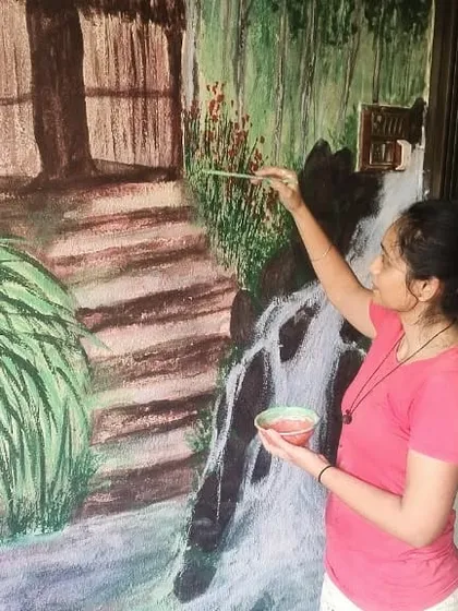 This is me working on a monsoon landscape mural. I wanted to capture the feeling of a Kerala village, with its lush greenery and gentle waterfall. It’s all about creating a mood.