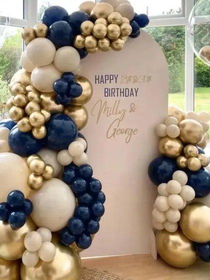 A classic and sophisticated balloon arrangement in navy blue, white, and gold. This setup is perfect for a joint birthday or an elegant corporate event.