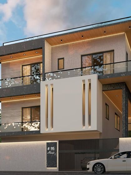 This facade design uses contrasting dark stone and white plaster to create a bold, modern aesthetic. The strategic placement of lighting and the cantilevered balconies add to the dynamic feel of the building.