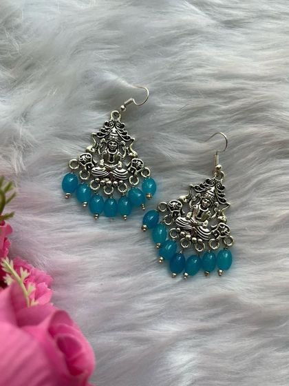 The popular Lakshmi temple earrings with blue beads, displayed on a soft background to highlight their craftsmanship.