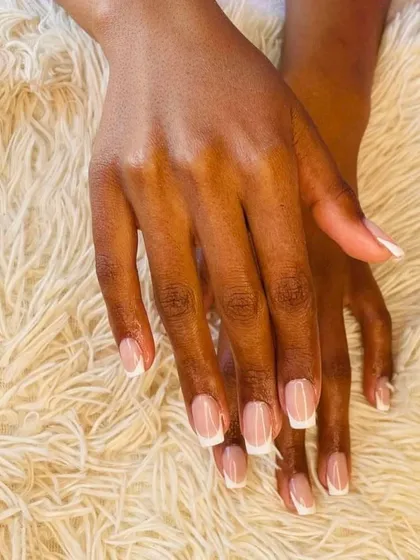 The perfect French manicure on a client with beautiful long nail beds. The proportions of the pink base and white tip are customized for a natural and flattering look.