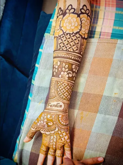 A close-up of the left hand, highlighting the name "Fardin" written elegantly on the wrist.