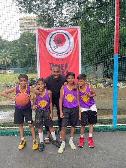 A coach and his young team, all smiles before their game. We focus on creating a positive and fun environment for our youngest athletes.