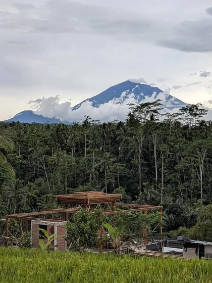 A view of Mount Agung from our project site in Bali. The architecture, with its timber framing and open design, is sited to pay homage to the powerful natural landscape that surrounds it.