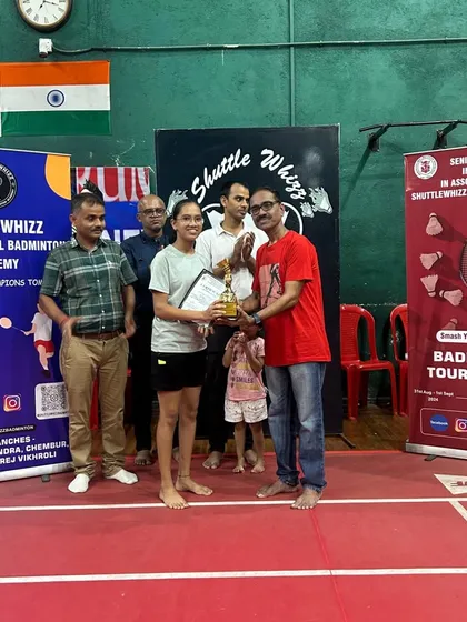 A female player is awarded her trophy at our in-house tournament, celebrating her victory and sportsmanship.