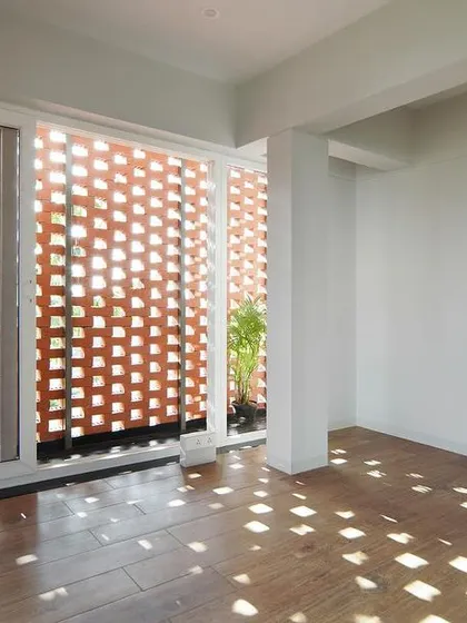 In my "House Belaku" project, I used a brick *jali* screen to transform sunlight into a dynamic design element. This image captures how the perforated brickwork casts a beautiful, shifting mosaic of light and shadow, creating a serene atmosphere while ensuring privacy.