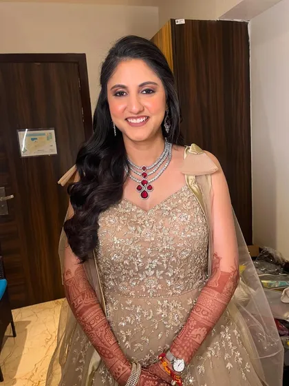 A happy and radiant bride, loving her sangeet look. The glowing skin and voluminous hair make her look and feel like a star.
