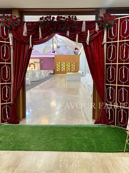 The grand entrance we created for a red and gold themed Valima. The velvet-paneled walls and dramatic draping set a luxurious tone for the event from the moment guests arrived.