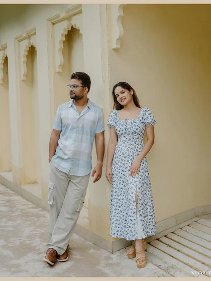 A classic, relaxed portrait of the couple against a yellow wall.