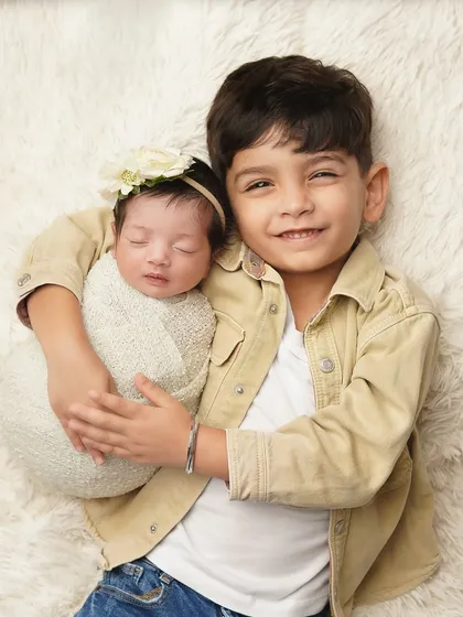 The moment a big brother meets his new best friend. Sibling photos are some of the most precious, capturing the start of a lifelong bond. I gently guide older siblings to interact with the newborn, ensuring we get authentic, heartwarming portraits.