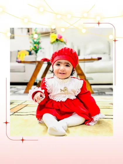 Another one of our little clients looking festive and bright in her Santa-inspired dress and matching cap.