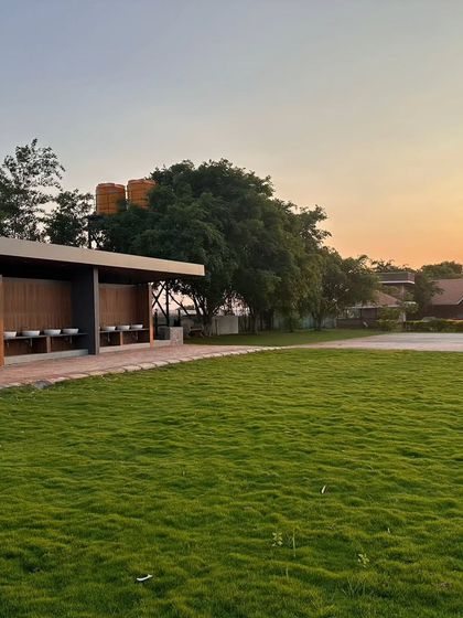 A wide expanse of lawn at a commercial property during sunset. Maintaining large turf areas like this requires a consistent schedule of mowing, fertilization, and weed control.
