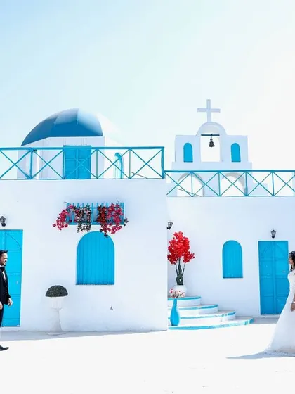 A pre-wedding shoot is your chance to get creative. I help couples choose unique locations, like this popular Santorini-themed set, to capture beautiful, magazine-worthy photos that tell a story before the wedding festivities begin.
