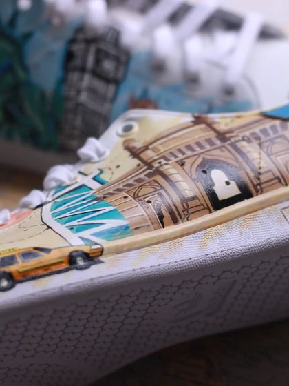 A close-up of the Mumbai-themed side of the travel sneakers, with the Gateway of India and a classic kaali-peeli taxi.