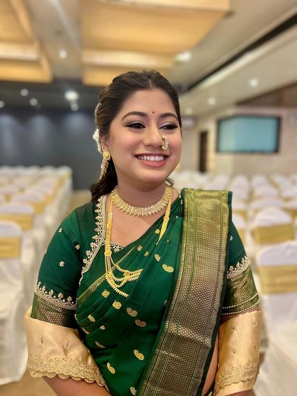 A classic portrait of my Maharashtrian bride. The makeup is kept soft and radiant to complement her elegant green and gold saree.