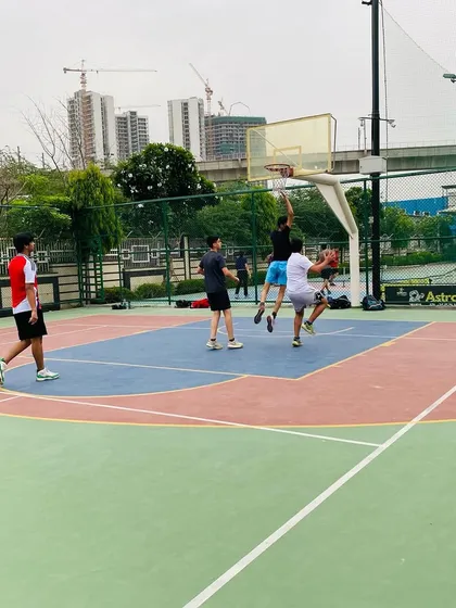 Intense action under the hoop as players fight for a rebound. This is where games are often won or lost.