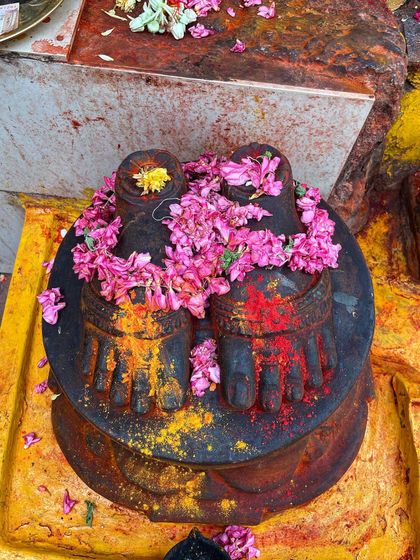 A depiction of Guru's feet, adorned with flowers. Sharath Jois preserved the Ashtanga method for millions of people. His life was a huge gift, and for me, a lesson in interdependence.