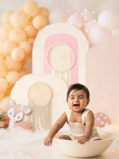 This little one is having a blast in a bowl, part of his fun-filled first birthday session.