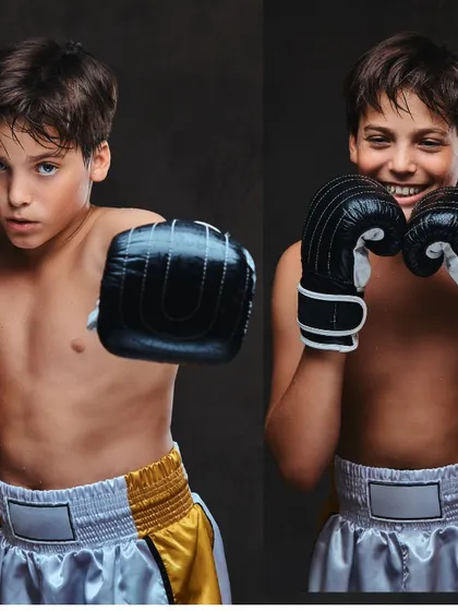 Two young boxers showing their fighting stance. I teach kids how to be both focused and have fun while learning the art of boxing.