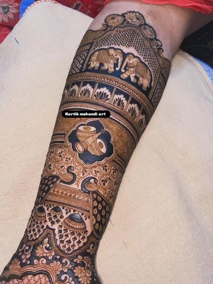 This section of a bridal arm features a dhol (drum) to represent the music and celebration of a wedding, along with graceful peacock designs.