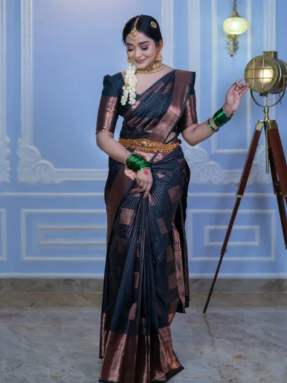 A full-length view of the black silk saree look, demonstrating how the outfit and makeup look from a distance. The posture is graceful and the overall effect is timeless.