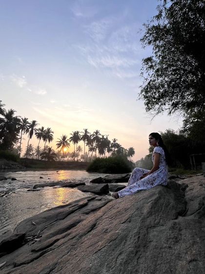 Sitting on the rocks by the river as the sun rises, casting a warm glow over the palm trees. This is my definition of a perfect morning.