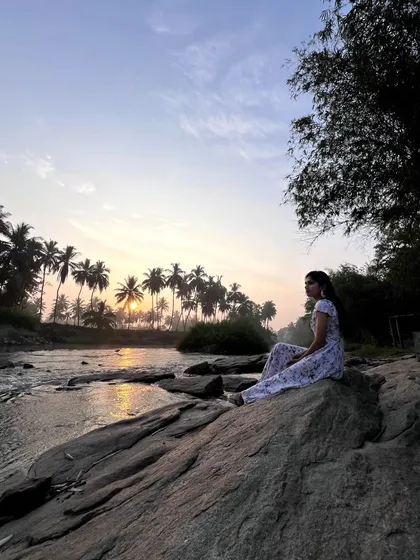 Sitting on the rocks by the river as the sun rises, casting a warm glow over the palm trees. This is my definition of a perfect morning.