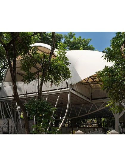 The restaurant deck is carefully integrated with the surrounding mature trees. The lightweight structure appears to float amidst the foliage, offering diners a unique experience of being nestled within the natural canopy.