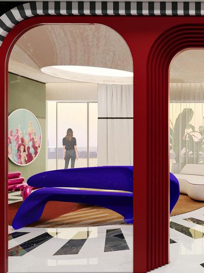 A view from the living room into the dining area, framed by a striking red arch with black and white striped trim.