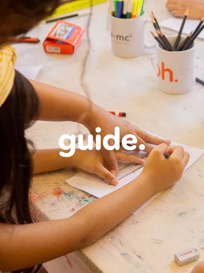 We see our role not as instructors who fill a pail, but as guides who light a fire. Here, a teacher helps a student refine her drawing, nurturing her creative spark.