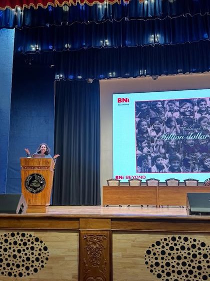 Speaking about my entrepreneurial journey to 1200 students at Kristu Jayanti College. This picture captures it all: me sharing my story, with a slide depicting the "million dollar smiles" that inspire my work.