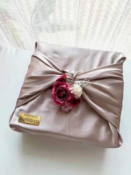 Presentation is everything. I use elegant techniques like Furoshiki, the Japanese art of fabric wrapping, to create a truly unique and sustainable unboxing experience for luxury gifts.