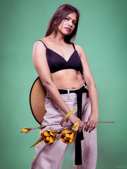 A full-body shot of the model against a green background, creating a vibrant contrast.