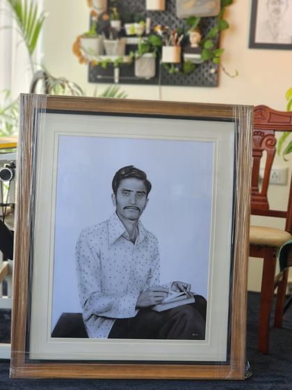 The finished and framed memorial portrait in my studio before delivery. The classic wooden frame adds to the timeless quality of the piece.