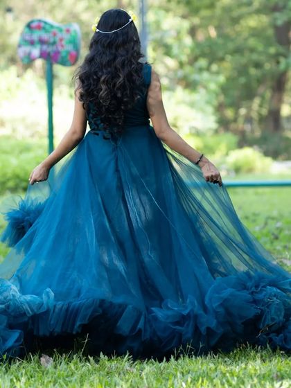 Live your own fairytale in this turquoise long-tail gown. The back view shows the beautiful flow and movement of the dress.