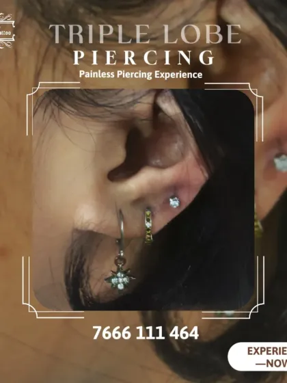 A close-up of a stylish triple lobe piercing. We help you create a personalized ear constellation with our painless piercing experience.