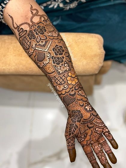 A full arm view of Rabiya's Pakistani bridal henna, showcasing the bold and intricate patterns.