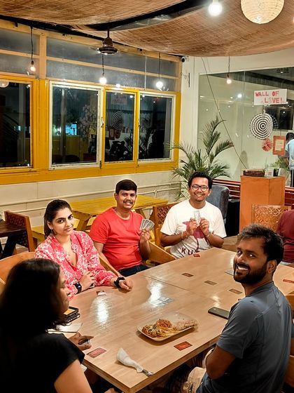 A full table of players enjoying a card game. My space can easily accommodate larger groups for game nights and social gatherings.