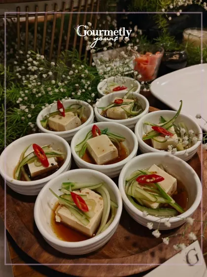 Silken tofu in a savory ponzu sauce, served in individual bowls. A light and flavorful option that is beautifully portioned for guests.