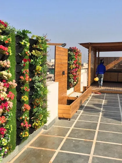 Your terrace can be a lush escape. This project features an artificial flower vertical garden that adds color and life to a rooftop seating area all year round, without any need for watering or upkeep.