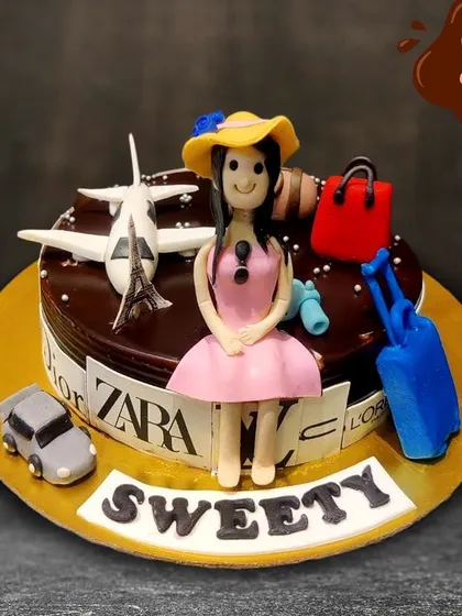 This cake is for the world traveler and fashionista. It features a fondant figure ready for adventure, surrounded by luggage, an airplane, the Eiffel Tower, and logos of her favorite brands like Dior and Zara.